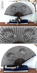 Traditional Chinese carved sandalwood folding fan with elegant hollow design and display stand.