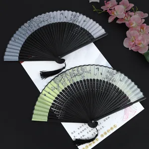 Traditional Chinese style folding hand fan with cherry blossom pattern and tassels for dance.