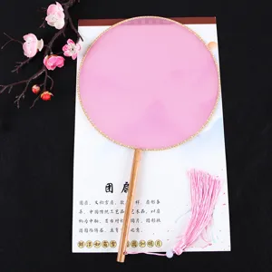 Handmade silk round fan traditional Chinese palace fan with wooden handle and pink tassel.