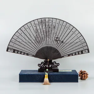 Black sandalwood folding fan with hollow carved design, traditional Chinese gift box.