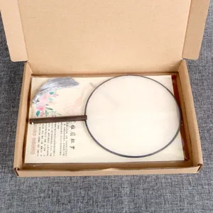 Traditional Chinese round fan with wooden handle and silver tassel in gift box packaging.