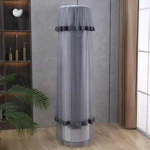 Grey mesh vertical cylinder air conditioner dust cover detail view in home living room setting.