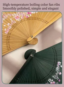 Detailed shot of Chinese style hollow carved bamboo folding fan with delicate floral pattern closeup.