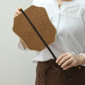 Handwoven traditional bamboo fan for summer cooling, portable natural material hand fan.