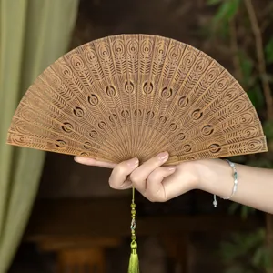 Natural wood folding fan with hollow carved pattern and elegant tassel for traditional hanfu.