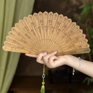 Natural sandalwood folding fan with carved floral design, elegant Chinese style prop.