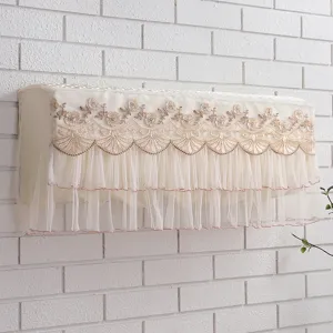 Detail view of beige lace embroidered wall-mounted air conditioner dust cover decor.