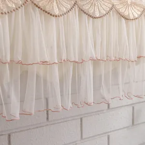 Close-up of elegant gold embroidered lace and white ruffled tulle mesh for air conditioner.