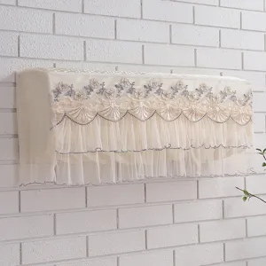 Detailed view of delicate floral embroidery and layered mesh ruffles on a decorative AC cover.