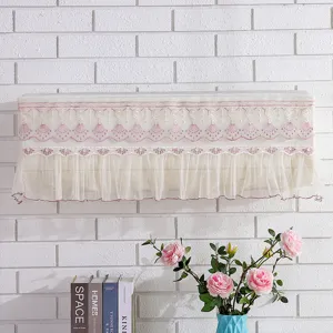 Close-up view of elegant lace hanging air conditioner dust cover with floral embroidery.