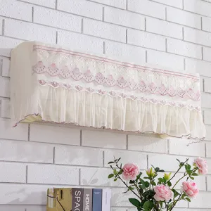 Detailed shot of beige mesh wall-mounted air conditioner cover with elegant pink lace trim.
