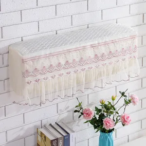 Detailed view of wall-mounted air conditioner dust cover with delicate pink lace embroidery.