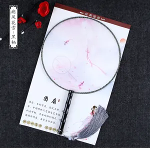Traditional Chinese round fan with wooden handle and elegant tassel for dance photography prop.