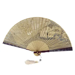 Traditional Chinese wooden folding fan with hollow carved landscape design and elegant tassel.