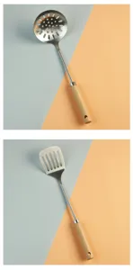 Stainless steel kitchen utensil detail, wooden handle skimmer and turner set for cooking.