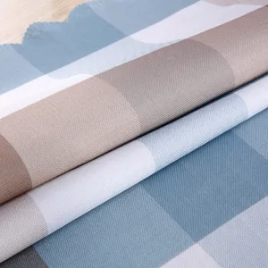 Close-up detail of soft blue, white and brown plaid fabric texture, showing clear material.