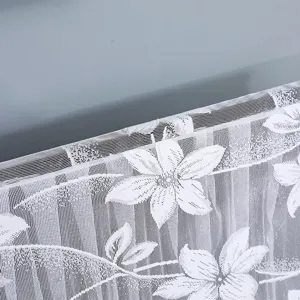 Close-up detail view of the white lace fabric featuring elegant floral patterns and fine mesh weave.
