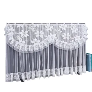 White lace TV dust cover with elegant floral embroidery and layered ruffles for home decor.