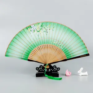 Traditional Chinese folding fan with green silk fabric, floral pattern, and wooden frame.