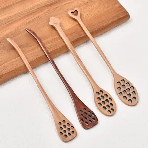 Long handle wooden honey spoons and coffee stirrers with cute hollow honeycomb design for home.