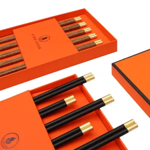 Chinese style wooden chopsticks gift set with luxury orange box and elegant gold tips.