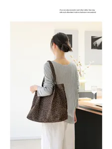 Modieuze canvas draagtas met luipaardprint gedragen op de schouder voor een casual look