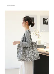 Luipaardprint canvas draagtas gedragen door een model in een minimalistisch huis