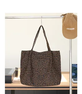 Canvas shopper met luipaardprint hangend aan een metalen rek in een lifestyle setting