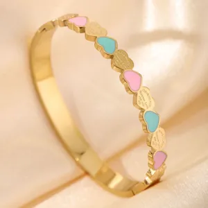 Elegant gold stainless steel heart enamel bangle bracelet for women fashion accessory.
