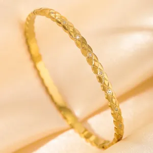 Gold stainless steel quilted diamond bangle bracelet detail, luxury vintage fashion jewelry.