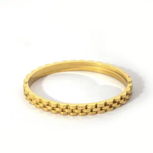 Stainless steel gold bangle with unique fluted edge design, stylish fashion jewelry accessory.