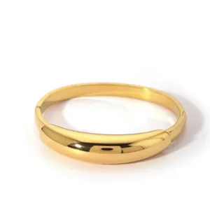 Gold chunky irregular metal bangle bracelet for women, stylish minimalist jewelry piece.