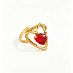 Close-up detail of the gold heart-shaped ring with brilliant red cubic zirconia stone.