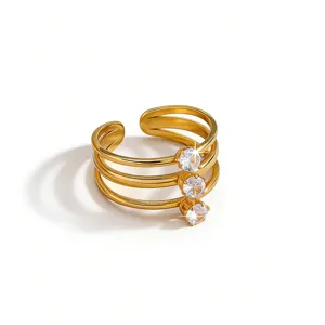 Exquisite gold-tone multi-band open ring featuring three sparkling cubic zirconia stones detail.