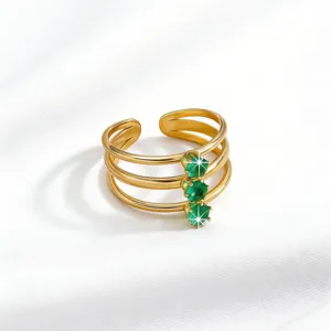 Detailed view of French vintage stainless steel triple-band open ring with green zircon stones.