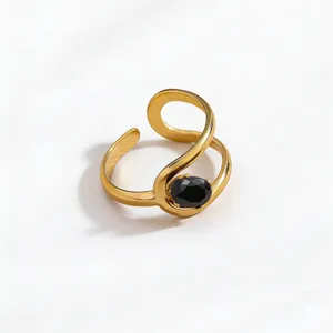 Detailed shot of a vintage gold-plated stainless steel open ring with a black crystal stone.