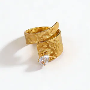 Close-up detail of the gold stainless steel hammered wrap ring featuring a sparkling teardrop zirconia.