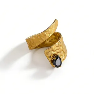 Close-up detail of the vintage wide wrap ring featuring hammered texture and black stone accent.