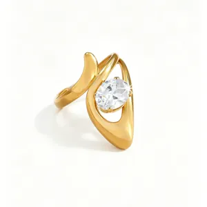 Close-up detail shot of a modern asymmetrical gold ring featuring an elegant oval white zircon.