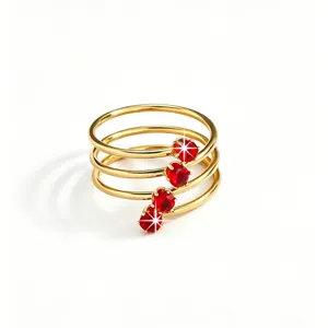 Detailed close-up of a multi-layer gold ring featuring sparkling red zircon stones elegance.