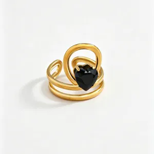 Gold stainless steel ring with black heart zircon, modern minimalist jewelry detail shot.