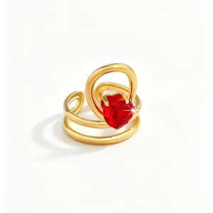 Detailed view of the luxury red heart zircon gold ring, elegant stainless steel band jewelry.