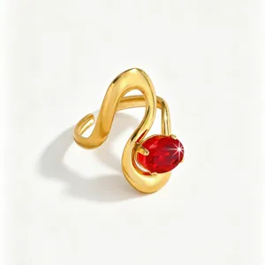 Detailed shot of gold-plated open ring featuring an oval red zircon and elegant wavy design.