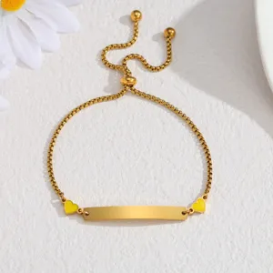 Gold stainless steel ID bracelet with yellow heart charms and adjustable slider chain for women.