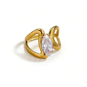 Detailed closeup view of a polished gold plated brass ring showcasing a clear marquise zircon.