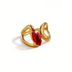 Detailed view of an elegant gold-plated brass ring featuring a striking marquise-cut red stone.