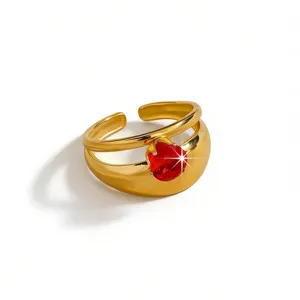 Detailed close-up view of the elegant gold-plated open ring featuring a sparkling red heart gemstone.
