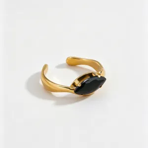 Detail view of a minimalist 18k gold plated stainless steel ring with a black marquise zircon.
