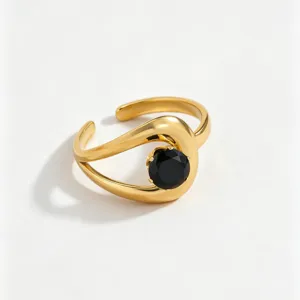 Gold-plated stainless steel open ring with a black cubic zirconia stone, detailed closeup view.