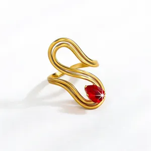 Elegant 18k gold plated curved statement ring featuring a radiant pear red gemstone detail.